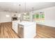 Modern kitchen island featuring a stainless steel dishwasher, sink, and pendant lighting at 2619 Bordwell Grant Dr, New Hill, NC 27562