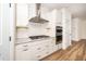 Close up of kitchen featuring stainless appliances, white cabinets, granite, and tile backsplash at 2619 Bordwell Grant Dr, New Hill, NC 27562