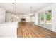 Open-concept living space with a fireplace, sliding glass doors, and seamless flow to the outdoors at 2619 Bordwell Grant Dr, New Hill, NC 27562