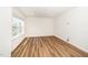 Neutral colored room with wood-look flooring, baseboards, recessed lighting, and a window at 2619 Bordwell Grant Dr, New Hill, NC 27562