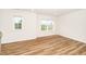 Room with wood-look flooring, white walls, baseboards, and two windows at 2619 Bordwell Grant Dr, New Hill, NC 27562