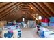 Spacious unfinished attic with exposed rafters and a window to let in natural light at 2661 Silver Bend Dr, Apex, NC 27539