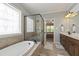 This luxurious bathroom features dual sinks, a soaking tub, and a frameless shower at 2661 Silver Bend Dr, Apex, NC 27539