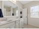 Bright bathroom featuring double sink vanity, large mirror, and tile flooring at 2661 Silver Bend Dr, Apex, NC 27539