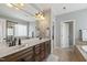 This luxurious bathroom features dual sinks, a soaking tub, and a frameless shower at 2661 Silver Bend Dr, Apex, NC 27539