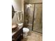 Stylish half-bathroom with patterned tile counter and decorative copper vessel sink next to glass shower at 2661 Silver Bend Dr, Apex, NC 27539