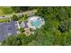 Aerial view of the community pool and amenities, surrounded by vibrant greenery and parking at 2661 Silver Bend Dr, Apex, NC 27539