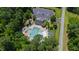 Aerial view of a community pool with parking, play area, and surrounded by mature trees at 2661 Silver Bend Dr, Apex, NC 27539