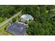 Aerial view of a community pool featuring ample seating and a spacious parking lot surrounded by lush trees at 2661 Silver Bend Dr, Apex, NC 27539