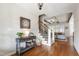 Stylish entryway featuring hardwood floors, staircase, console table, and decorative elements at 2661 Silver Bend Dr, Apex, NC 27539