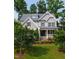 Beautiful two-story home with a manicured lawn, mature trees, and a welcoming front porch at 2661 Silver Bend Dr, Apex, NC 27539