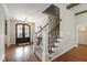 Elegant foyer with hardwood floors, staircase, and chandelier, creating a welcoming entrance at 2661 Silver Bend Dr, Apex, NC 27539