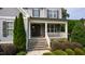 Inviting front porch with stone steps, decorative columns, and a charming entrance to the home at 2661 Silver Bend Dr, Apex, NC 27539