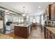 Open concept kitchen with granite countertops, hardwood floors and views of the living room at 2661 Silver Bend Dr, Apex, NC 27539