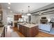 Open concept kitchen with island, granite countertops, hardwood floors and stainless appliances at 2661 Silver Bend Dr, Apex, NC 27539