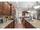 Well-equipped kitchen with granite countertops, stainless steel appliances, and wooden cabinetry at 2661 Silver Bend Dr, Apex, NC 27539