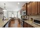 Spacious kitchen with granite counters, stainless appliances, and hardwood floors at 2661 Silver Bend Dr, Apex, NC 27539