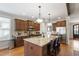 Spacious kitchen featuring a large granite island, stainless steel appliances and dark wood cabinets at 2661 Silver Bend Dr, Apex, NC 27539