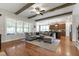 Cozy living room featuring hardwood floors, exposed beams, and an open view to the kitchen at 2661 Silver Bend Dr, Apex, NC 27539