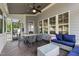 Inviting screened porch with comfortable seating, a dining table, and an outdoor fan for relaxation at 2661 Silver Bend Dr, Apex, NC 27539