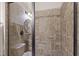 Modern bathroom shower features large brown wall tiles and sleek glass doors at 2661 Silver Bend Dr, Apex, NC 27539