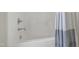 Clean, white bathtub and shower combination with chrome fixtures and a neutral shower curtain at 2661 Silver Bend Dr, Apex, NC 27539