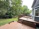 Multi-tiered wooden deck with lush greenery, perfect for outdoor entertaining at 2708 Halfhitch Trl, Raleigh, NC 27615