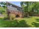 View of back exterior of home with wooden deck, large yard, and partial shade at 2708 Halfhitch Trl, Raleigh, NC 27615