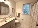 Full bathroom with vanity, decorative mirror, and shower with patterned curtain at 2708 Halfhitch Trl, Raleigh, NC 27615