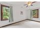 Bright bedroom featuring two windows, carpet, and a ceiling fan creating a serene atmosphere at 2708 Halfhitch Trl, Raleigh, NC 27615