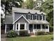 Charming two-story home features a gray exterior, front porch with white railing, and lush landscaping at 2708 Halfhitch Trl, Raleigh, NC 27615