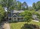 Well-maintained home exterior with mature trees, landscaping and long driveway at 2708 Halfhitch Trl, Raleigh, NC 27615