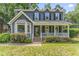 Charming two-story home with a covered front porch, well-maintained lawn, and manicured landscaping at 2708 Halfhitch Trl, Raleigh, NC 27615