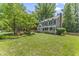 Beautifully landscaped front yard with mature trees, flowering bushes, and a green lawn at 2708 Halfhitch Trl, Raleigh, NC 27615