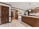Well-lit kitchen featuring stainless steel appliances, wooden cabinets, and an eat-in bar at 2708 Halfhitch Trl, Raleigh, NC 27615