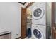 Laundry area with stacked washer and dryer and shelves for storage at 2708 Halfhitch Trl, Raleigh, NC 27615