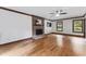 Spacious living room featuring a brick fireplace, hardwood floors, and natural light from the windows at 2708 Halfhitch Trl, Raleigh, NC 27615