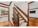 Carpeted staircase with wood banister and trim throughout hallway entrance adds a touch of elegance to the home at 2708 Halfhitch Trl, Raleigh, NC 27615