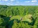 Aerial view of lush green landscape with structures at 2815 Orange Grove Rd, Hillsborough, NC 27278