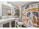 Charming bathroom featuring a quirky shower curtain and floating shelving at 2815 Orange Grove Rd, Hillsborough, NC 27278