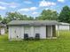 Exterior of building with siding and two chairs with table on grass at 2815 Orange Grove Rd, Hillsborough, NC 27278