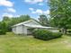 Exterior of home featuring manicured bushes, lush greenery, and ample parking at 2815 Orange Grove Rd, Hillsborough, NC 27278