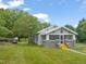Inviting home with well-kept landscaping, featuring a screened porch, yellow stairs and outdoor seating at 2815 Orange Grove Rd, Hillsborough, NC 27278
