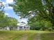 Well-maintained home surrounded by lush greenery, showcasing a lovely screened porch and ample yard space at 2815 Orange Grove Rd, Hillsborough, NC 27278