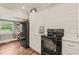 Modern kitchen with black appliances, white cabinets, and lots of natural light at 2815 Orange Grove Rd, Hillsborough, NC 27278