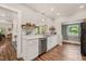 Well-lit kitchen featuring white cabinets, stainless steel appliances, and butcher block countertops at 2815 Orange Grove Rd, Hillsborough, NC 27278