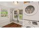 Convenient laundry room with stacked washer and dryer, natural light, and easy access to the backyard at 2815 Orange Grove Rd, Hillsborough, NC 27278