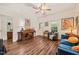 Spacious living room with wood floors, a piano, and comfortable seating, perfect for entertaining guests at 2815 Orange Grove Rd, Hillsborough, NC 27278