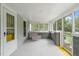 Relaxing screened-in porch with a porch swing, perfect for enjoying the outdoors in comfort at 2815 Orange Grove Rd, Hillsborough, NC 27278