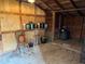 The shed displays exposed beams, a chair, potted plants, and storage containers, offering potential as a workshop or storage at 2815 Orange Grove Rd, Hillsborough, NC 27278